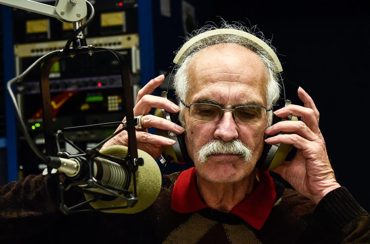 Jeff Ruth adjusts his headphones after speaking to listeners in this Marion Star file photo. Today, Ruth is sports director and public affairs director at WZMO in Marion.