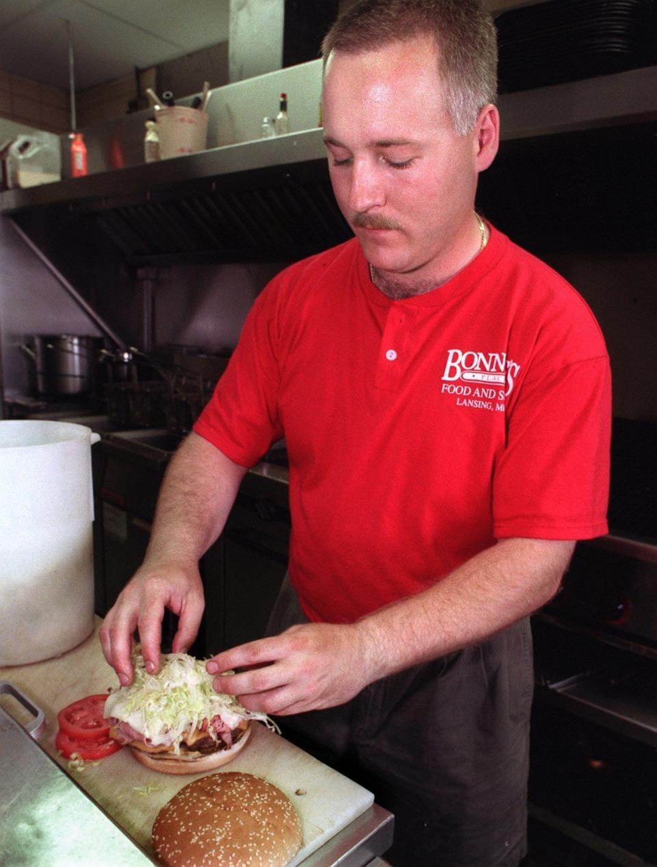 Cook Scott Feltenberger assembles a Bonnie Burger at Bonnie's Place on June 11, 1999.