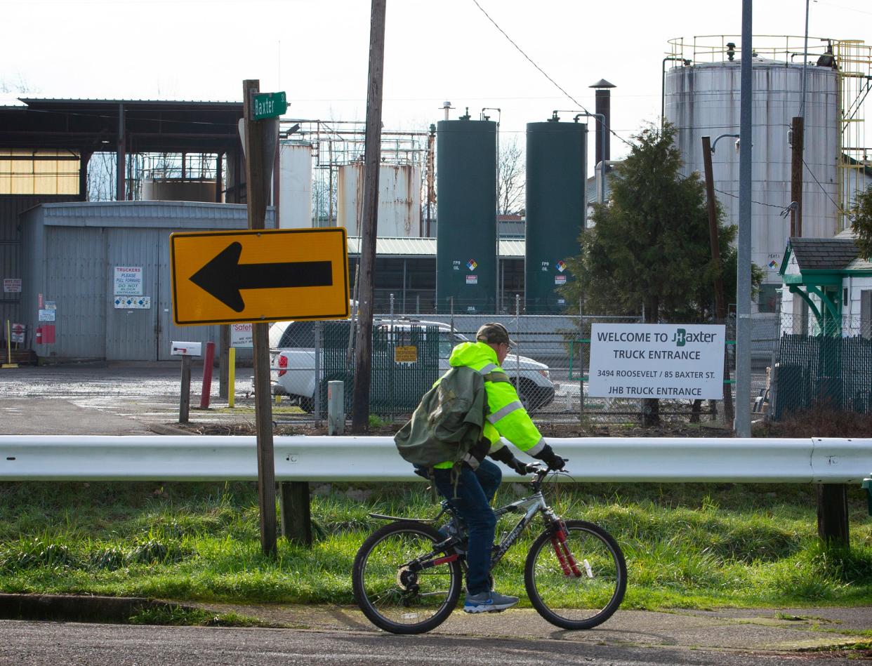 A bicyclist passes near the J.H. Baxter & Co. plant in Eugene. 