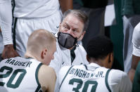 Michigan State coach Tom Izzo, center, talks to players during a timeout in the second half of an NCAA college basketball game against Indiana, Tuesday, March 2, 2021, in East Lansing, Mich. Michigan State won 64-58. (AP Photo/Al Goldis)