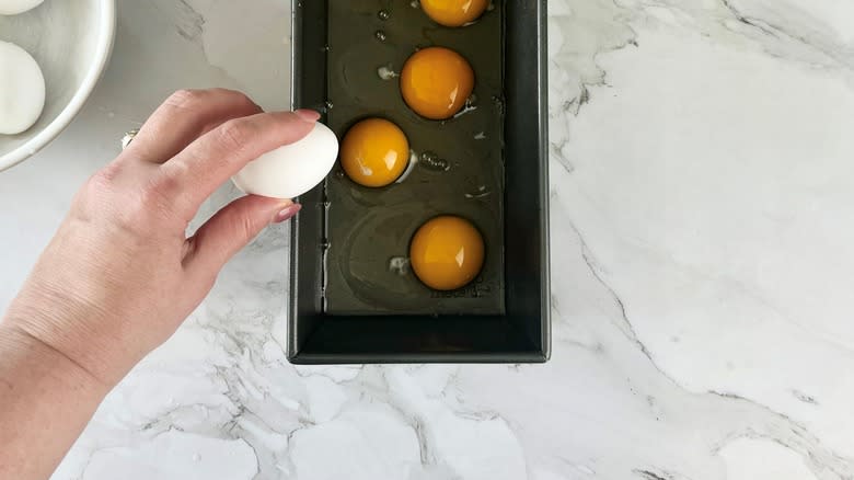 eggs cracked into loaf pan