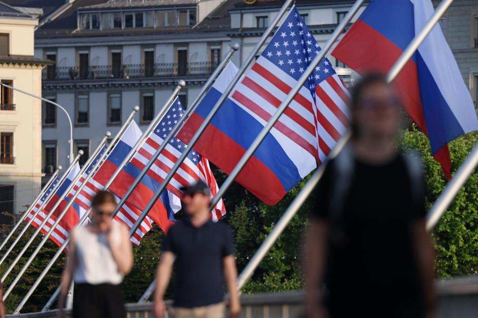 People walk under Russian and American flags on a bridge in Geneva prior to the meeting between Joe Biden and Russian Vladimir Putin (Getty Images)