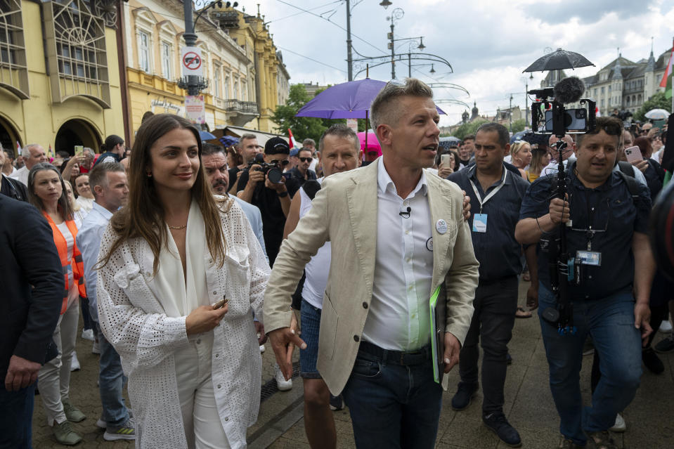 Péter Magyar, a rising challenger to Hungarian Prime Minister Viktor Orbán, arrives with his girlfriend to address people at a campaign rally in the rural city of Debrecen, Hungay, on Sunday, May 5, 2024. Magyar, whose TISZA party is running in European Union elections, has managed to mobilize large crowds of supporters on a campaign tour of Hungary's heartland, a rarity for an Orbán opponent. (AP Photo/Denes Erdos)