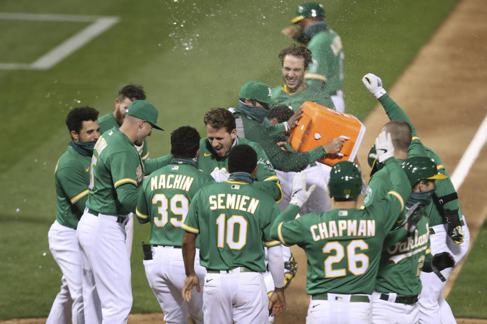 Oakland Athletics' Stephen Piscotty celebrates with teammates after a game-ending grand slam against the Texas Rangers during the ninth inning of a baseball game in Oakland, Calif., Tuesday, Aug. 4, 2020. The A's won 5-1. (AP Photo/Jed Jacobsohn)