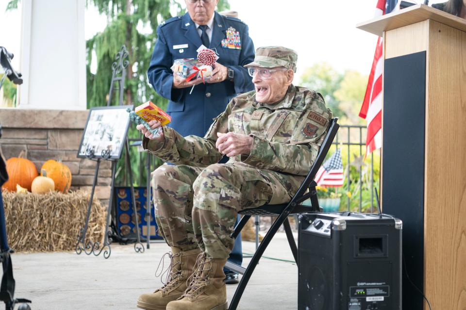 Veteran Bob Munie is presented with gifts from the Blue Star Mothers for his 100th birthday at Lakeview Assisted Living in Battle Creek on Thursday, Oct. 6, 2022.