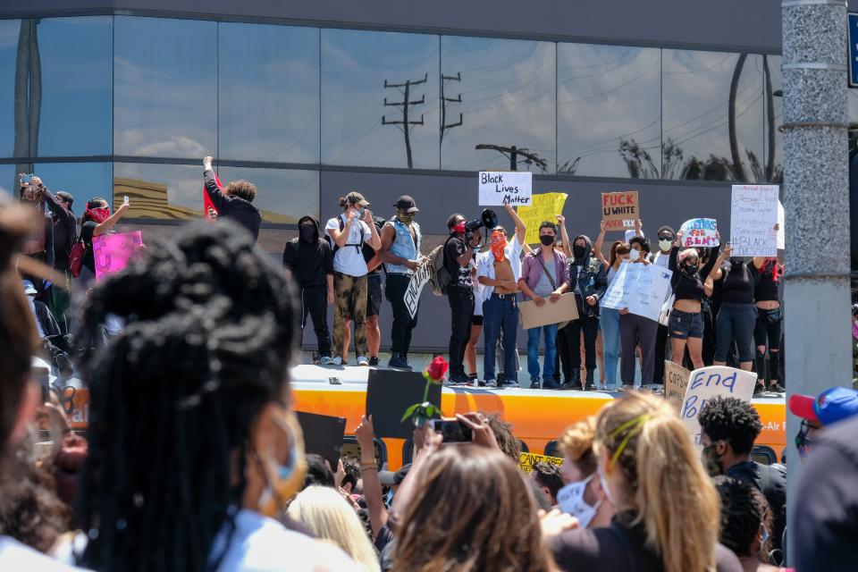 Protestors stand on a bus at 3rd Street and Fairfax in Los Angeles on March 30. Photo by Stacey Leasca.