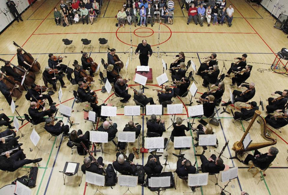 In this photo taken Monday, Sept. 24, 2012, the Musicians of the Minnesota Orchestra perform under the conducting of Kenneth Freed in a gymnasium at the ACME Concert, a free event at the North Community YMCA, in Minneapolis. The Minnesota Orchestra was called the world's greatest not long ago, welcome recognition for musicians outside a top cultural center. Now its members are locked out of Orchestra Hall, stuck in the same kind of labor-management battle recently afflicting teachers and football referees. (AP Photo/Stacy Bengs)