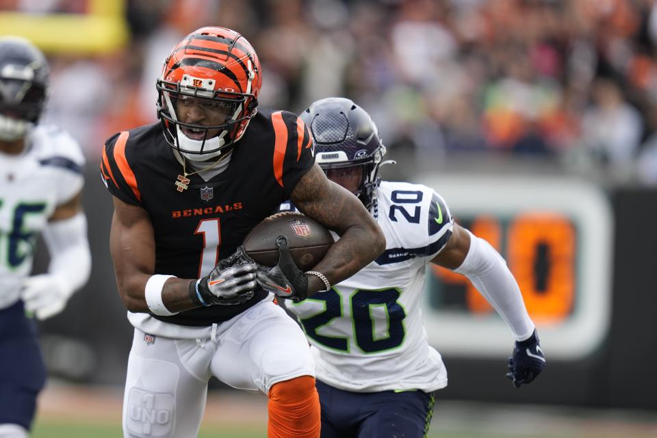 Cincinnati Bengals' Ja'Marr Chase (1) runs against Seattle Seahawks' Julian Love during the first half of an NFL football game, Sunday, Oct. 15, 2023, in Cincinnati. (AP Photo/Michael Conroy)