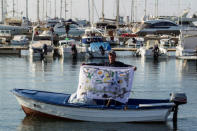 A fisherman holds a banner during a protest against undersea oil exploration in the Adriatic Sea in Bar, Montenegro, November 14, 2018. REUTERS/Stevo Vasiljevic