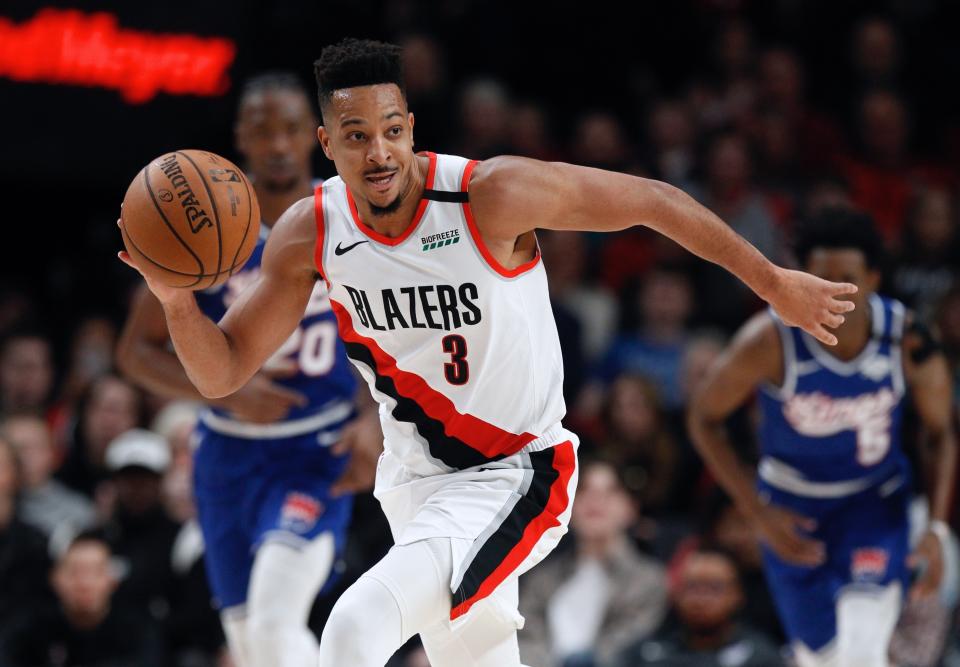 Portland Trail Blazers guard CJ McCollum pushes the ball upcourt against the Sacramento Kings during the first half of an NBA basketball game in Portland, Ore., Saturday, March 7, 2020. (AP Photo/Steve Dipaola)