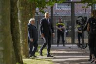 King Willem-Alexander, second left, arrives to officially unveil a new monument in the heart of Amsterdam's historic Jewish Quarter on Sunday, Sept. 19, 2021, honoring the 102,000 Dutch victims of the Holocaust. Designed by Polish-Jewish architect Daniel Libeskind, the memorial is made up of walls shaped to form four Hebrew letters spelling out a word that translates as "In Memory Of." The walls are built using bricks each of which is inscribed with the name of one of the 102,000 Jews, Roma and Sinti who were murdered in Nazi concentration camps during World War II or who died on their way to the camps. (AP Photo/Peter Dejong)