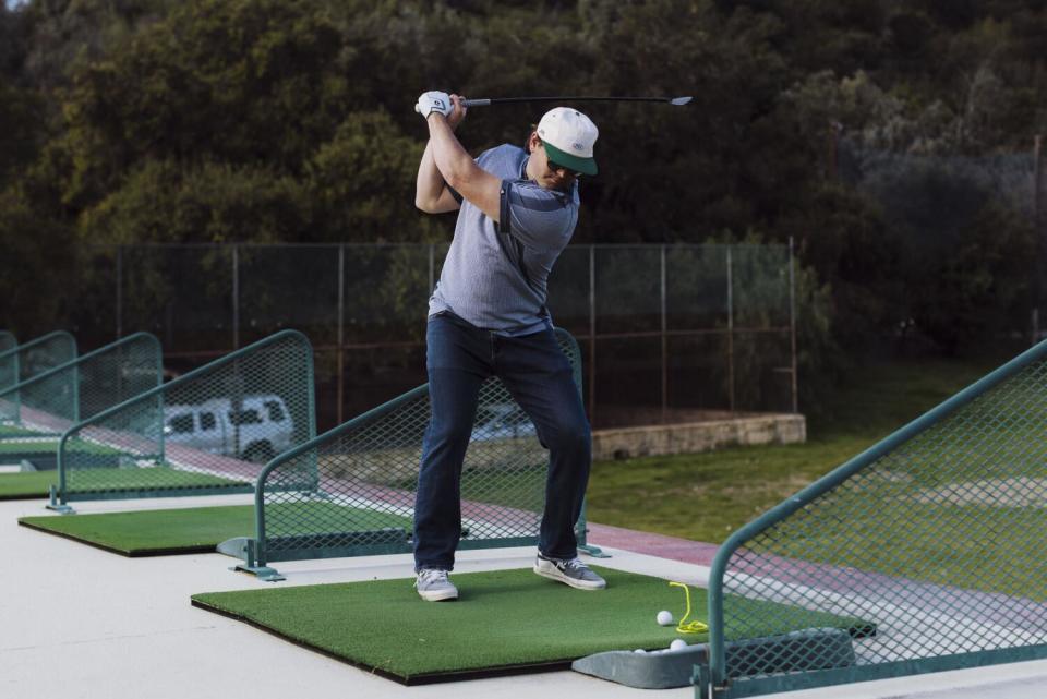 Dave Fink drives a ball at the Wilson Harding Driving Range.