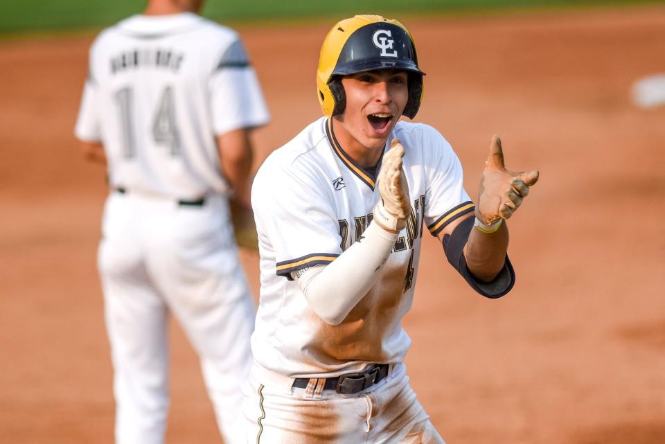Grand Ledge's Caleb Estrada celebrates after hitting a RBI triple against Olivet in the first inning on Monday, June 5, 2023, at McLane Stadium on the Michigan State University campus in East Lansing.