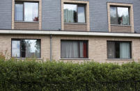 A resident in the window of a nursing home speaks with his relative from the window of his room at the Molenheide elderly care home in Wijnegem, Belgium on Tuesday, Aug. 18, 2020.Authorities in Belgium fear another deadly wave of coronavirus cases could soon hit care homes as the country confronts the risk of seeing its hospitals overwhelmed by COVID-19 patients, leading them to restrict nursing home visits. (AP Photo/Virginia Mayo)