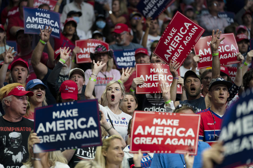 Supporters of President Donald Trump cheer as Vice President Mike Pence speaks during a campaign rally at the BOK Center, Saturday, June 20, 2020, in Tulsa, Okla. Trump is asking Americans to let him keep his job. His critics are asking how much of that job he’s actually doing. Those questions have gotten louder in recent days following revelations that Trump didn’t read at least two written intelligence briefings detailing concerns that Russia was paying bounties to the Taliban for the deaths of Americans in Afghanistan. (AP Photo/Evan Vucci)