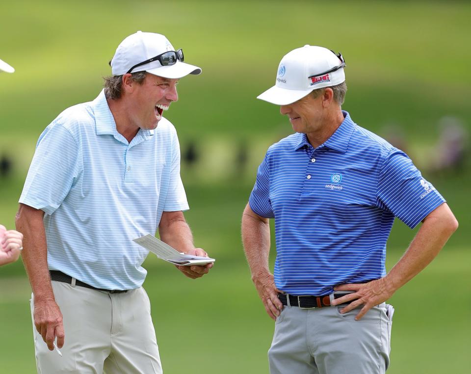 Stephen Ames, left, and David Toms share a laugh on the 7th hole during first round of the Bridgestone Senior Players Tournament at Firestone Country Club on Thursday.