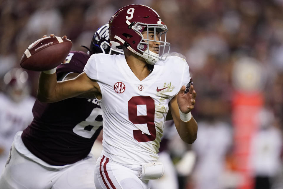 Alabama quarterback Bryce Young (9) is pressured by Texas A&M defensive lineman DeMarvin Leal (8) during the first half of an NCAA college football game Saturday, Oct. 9, 2021, in College Station, Texas. (AP Photo/Sam Craft)