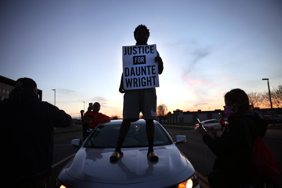 <p>Protest near the Brooklyn Center police station on 16 April  in Minnesota in the wake of the fatal shooting of 20-year-old Daunte Wright by Brooklyn Center police officer </p> (Getty Images)