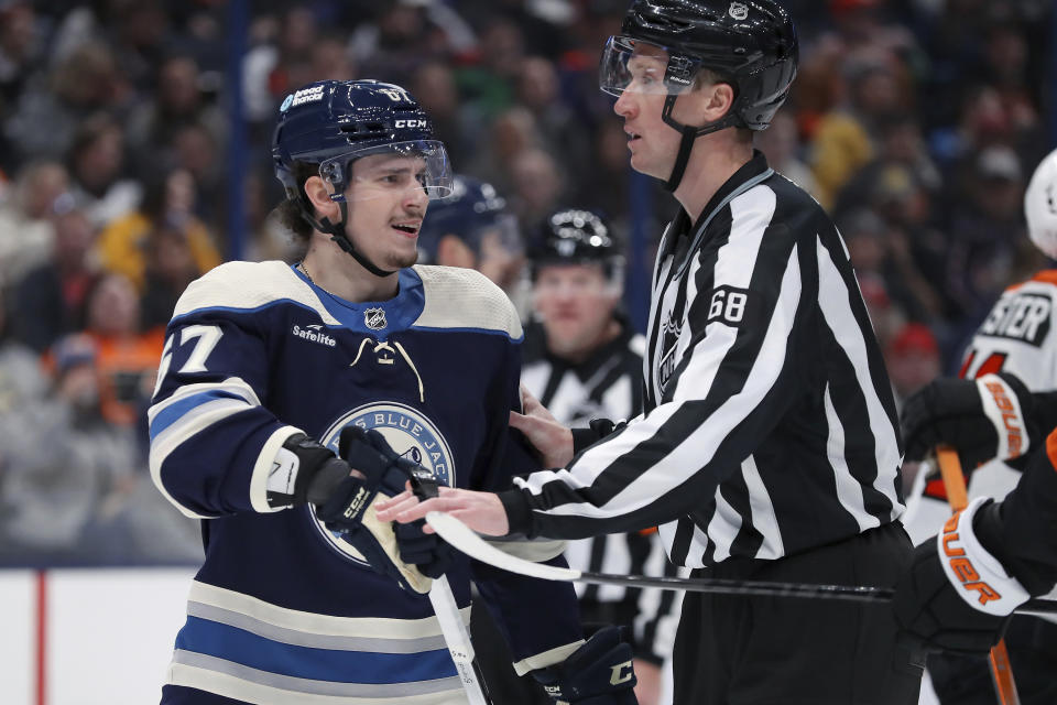 Columbus Blue Jackets left wing James Malatesta (67) is restrained by linesperson CJ Murray during the second period of the team's NHL hockey game against the Philadelphia Flyers, Saturday, April 6, 2024, in Columbus, Ohio. (AP Photo/Joe Maiorana)