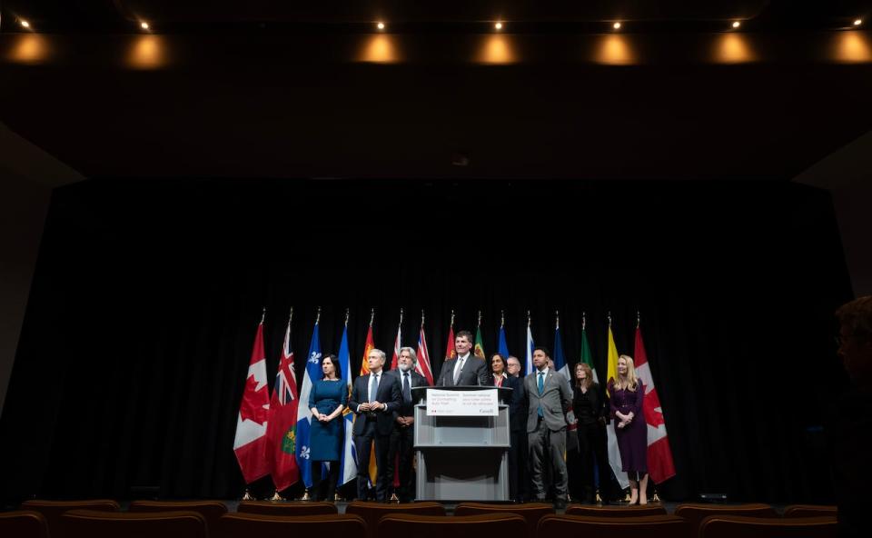 Cabinet members, police and municipal leaders surround Minister of Public Safety Dominic LeBlanc as he speaks during a news conference at the National Summit on Combatting Auto Theft, in Ottawa, Thursday, Feb. 8, 2024.
