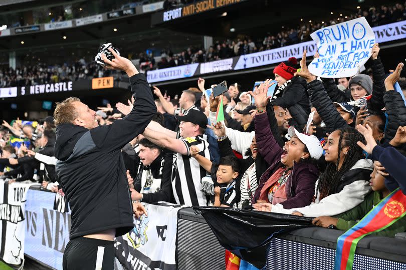 Dan Burn throws his shirt to Newcastle United fans in Melbourne