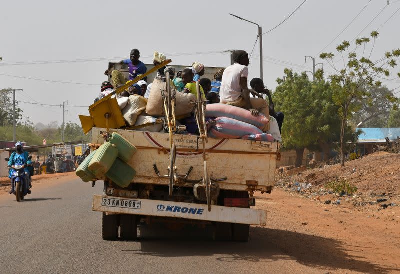 FILE PHOTO: Displaced people, who fled from attacks by armed militants in the town of Roffenega arrive on a truck in the city of Kaya