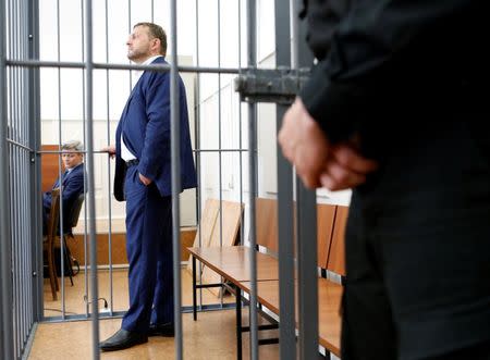 Governor of Kirov region Nikita Belykh, who is accused by the Investigative Committee of taking a bribe, stands inside a defendants' cage during a hearing at the Basmanny district court in Moscow, Russia, June 25, 2016. REUTERS/Maxim Zmeyev