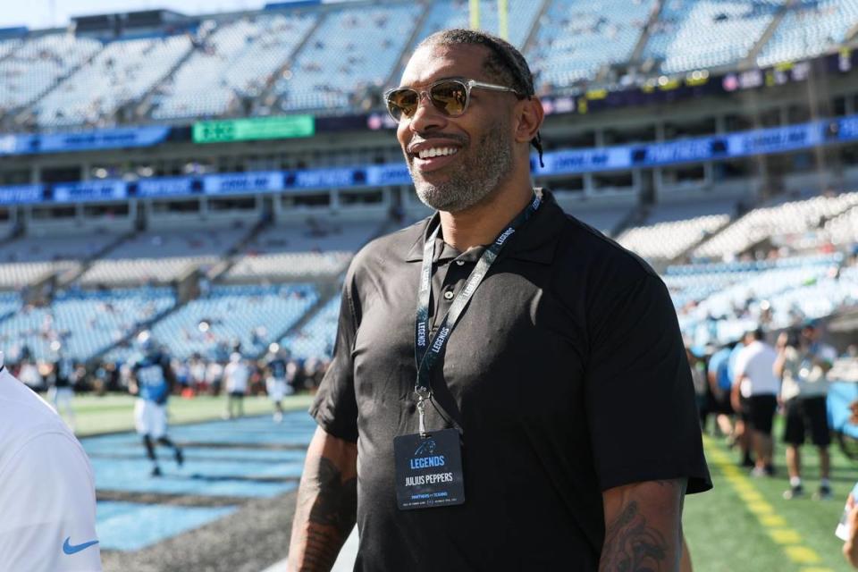 Panthers legend Julius Peppers walks the sidelines before the game against the Texans at Bank of America Stadium on Sunday, October 29, 2023.