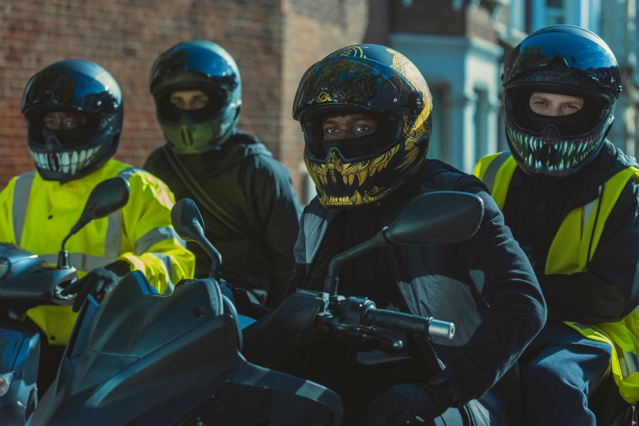 a group of people wearing helmets and riding a motorcycle in gassed up movie