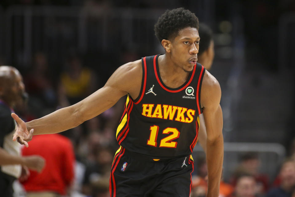 Atlanta Hawks forward De'Andre Hunter (12) celebrates after making a 3-point basket in the first half of an NBA basketball game against the New Orleans Pelicans, Sunday, March 20, 2022, in Atlanta. (AP Photo/Brett Davis)