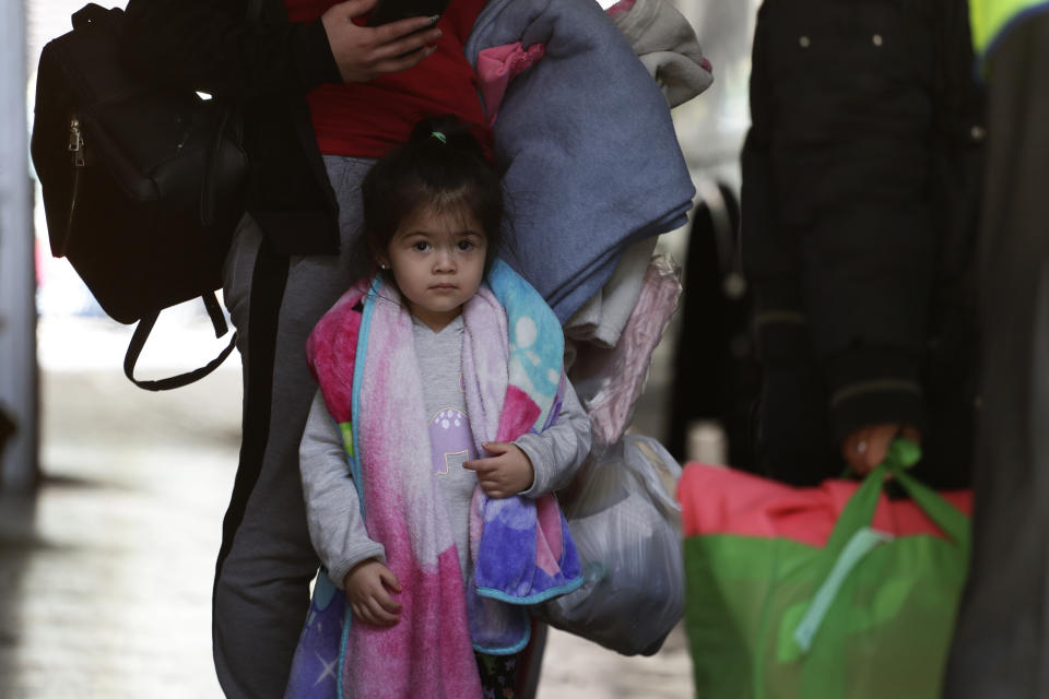 Immigrants from Central America seeking asylum board a bus, Tuesday, April 2, 2019, in downtown San Antonio. The surge of migrants arriving at the southern border has led the Trump administration to dramatically expand a practice it has long mocked as "catch and release." (AP Photo/Eric Gay)