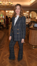 <p> A good suit should be an essential part of a capsule wardrobe. The presenter wore a double-breasted blazer and matching bootcut trousers, featuring a chic black and white check print, to an event in aid of Cancer Research UK at Fortnum & Mason in London in 2020. She paired her suit with a silky ivory top and bouncy locks. </p>