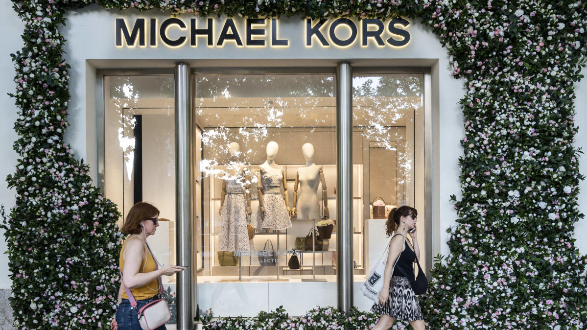 UPDATE 2-Michael Kors-owner beats quarterly estimates on resilient luxury  demand