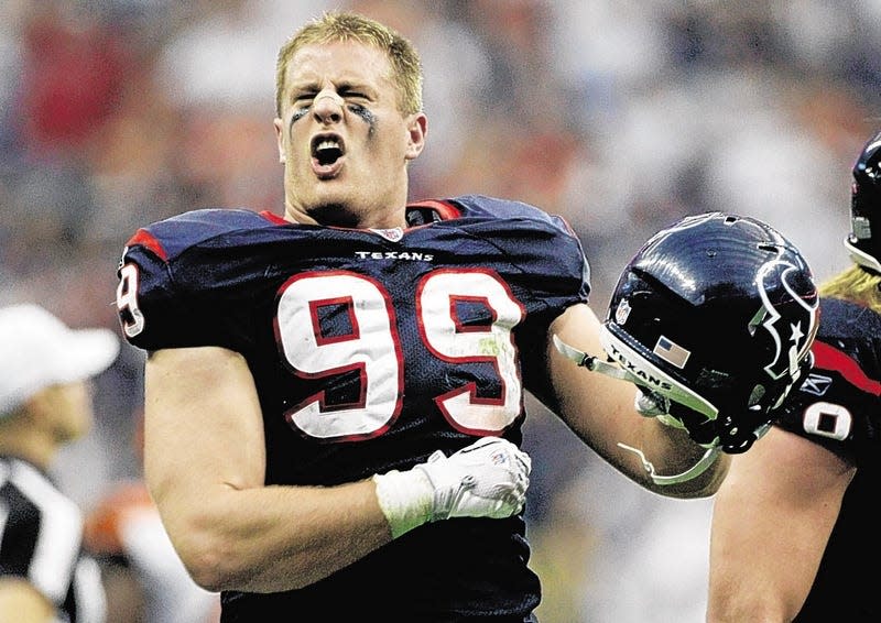 Houston Texans defensive end J.J. Watt celebrates returning an interception for a touchdown against Cincinnati Bengals quarterback Andy Dalton for one of the biggest plays in Texans' history during the second quarter of an NFL wild-card playoff football game in Houston after the 2011 season.