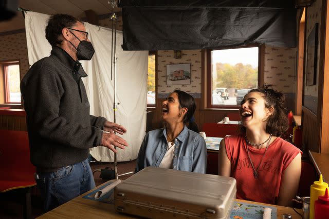 <p>Wilson Webb/Focus Features</p> (Left-right:) Ethan Coen, Geraldine Viswanathan and Margaret Qualley on the set of "Drive-Away Dolls"