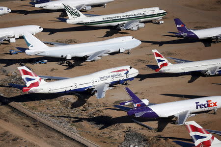 Old airplanes, including British Airways and Evergreen International Boeing 747-400s, are stored in the desert in Victorville, California March 13, 2015. REUTERS/Lucy Nicholson