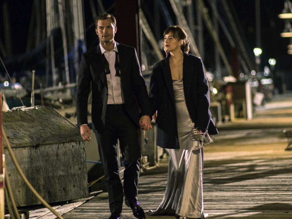 This image released by Universal Pictures shows Dakota Johnson as Anastasia Steele, right, and Jamie Dornan as Christian Grey in "Fifty Shades Darker." (Doane Gregory/Universal Pictures via AP)