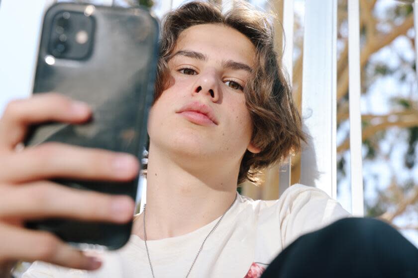 Sherman Oaks, CA - July 03: William Schnider, a 17-year-old at Van Nuys High School and a student in the medical magnet program, is against the cellphone ban at LAUSD schools, and here he poses for a portrait at Van Nuys Sherman Oaks Park on Wednesday, July 3, 2024 in Sherman Oaks, CA. (Dania Maxwell / Los Angeles Times)