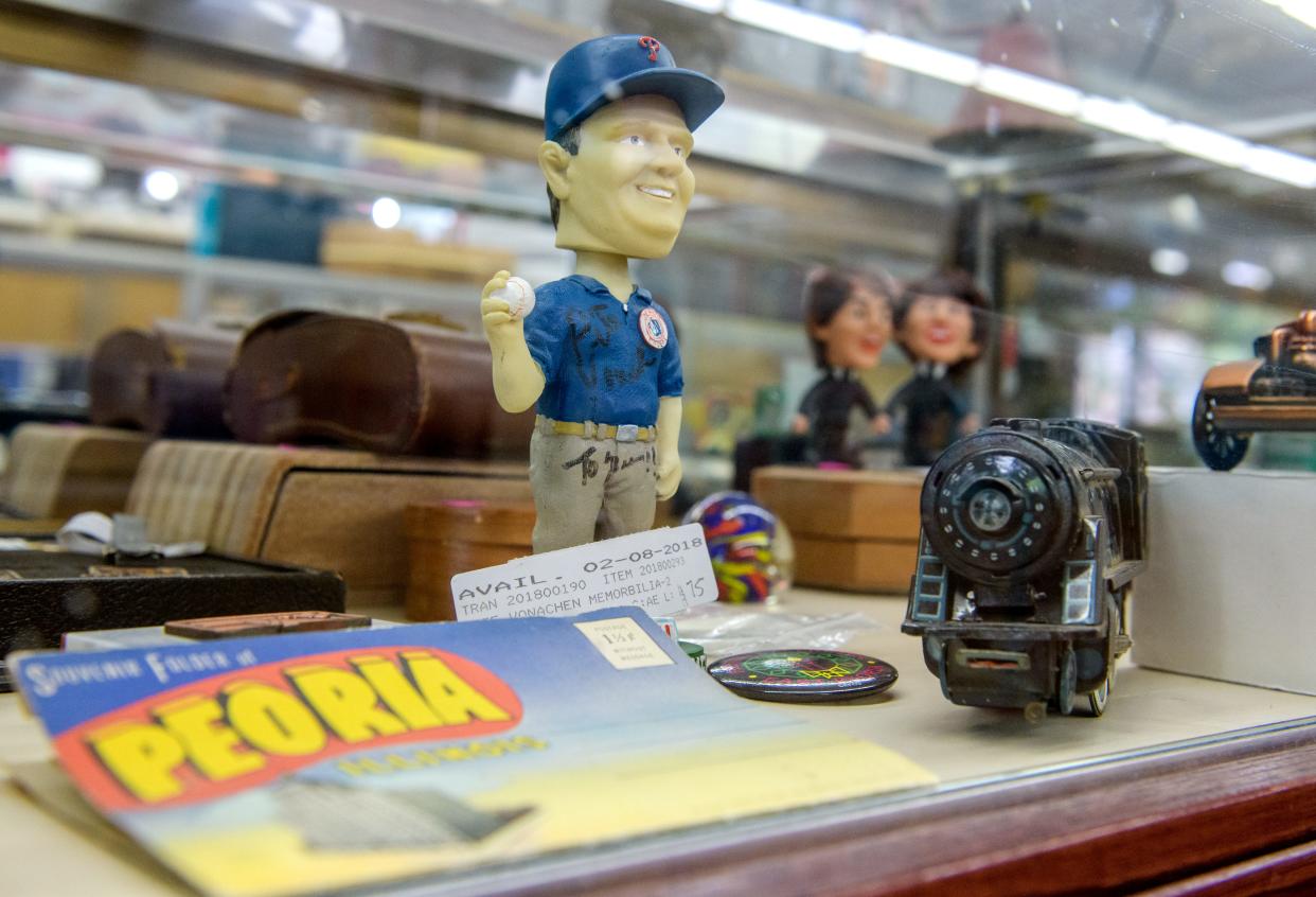 A vintage autographed bobblehead of the late Peoria Chiefs owner Pete Vonachen sits in a display case of collectibles at the A-Z Jewelry & Swap Shop in downtown Peoria.