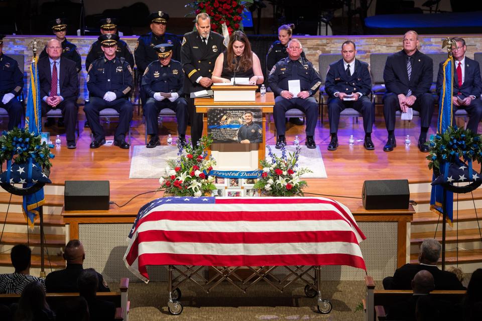 Katarina Blakely, wife of Knox County sheriff's deputy Tucker Blakely, smiles as she recalls sweet memories during a service at Clear Springs Baptist Church in Corryton.