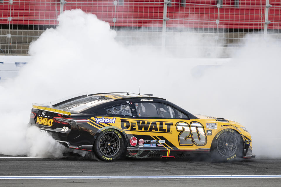 Christopher Bell (20) does a burnout after winning a NASCAR Cup Series auto race at Charlotte Motor Speedway, Sunday, Oct. 9, 2022, in Concord, N.C. (AP Photo/Matt Kelley)