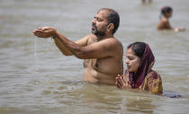 Hindu devotees offer prayers in the River Ganges, during the Ganga Dussehra festival, in Prayagraj, India, Monday, June 1, 2020. Hundreds of Hindu devotees made holy dips here Monday even though congregations at religious venues continue to remain barred during the nationwide coronavirus lockdown. (AP Photo/Rajesh Kumar Singh)