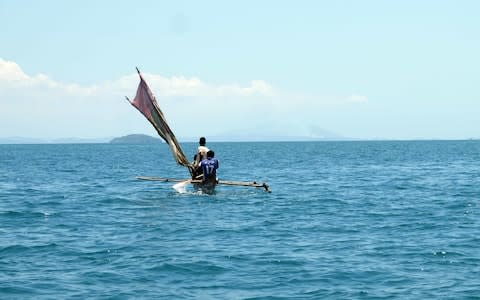 Local fishermen on board a pirogue. - Credit: simon J pierce