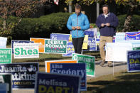 Voters walk through a sea of campaign signs at a polling station in Richmond, Va., Tuesday, Nov. 5, 2019. All seats in the Virginia House of Delegates and State senate are up for election. (AP Photo/Steve Helber)