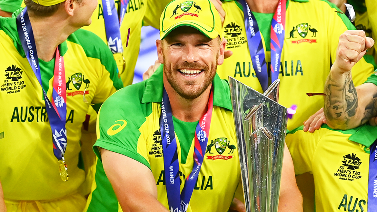 Aaron Finch (pictured) holding the T20 World Cup trophy.