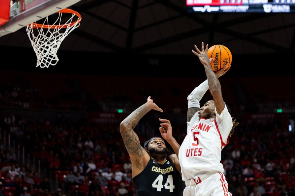 Utah Utes guard Deivon Smith (5) shoots the ball with Colorado Buffaloes center Eddie Lampkin Jr. (44) on defense during the men’s college basketball game between the Utah Utes and the Colorado Buffaloes at the Jon M. Huntsman Center in Salt Lake City on Saturday, Feb. 3, 2024. The teams are tied 31-31 at half-time.