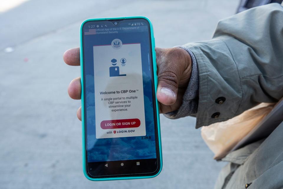 A migrant from Venezuela holds his phone showing the Customs and Border Protection app used to register in order to seek asylum in Ciudad Juarez. The app had launched two days prior but the migrant says he was not able to access it.