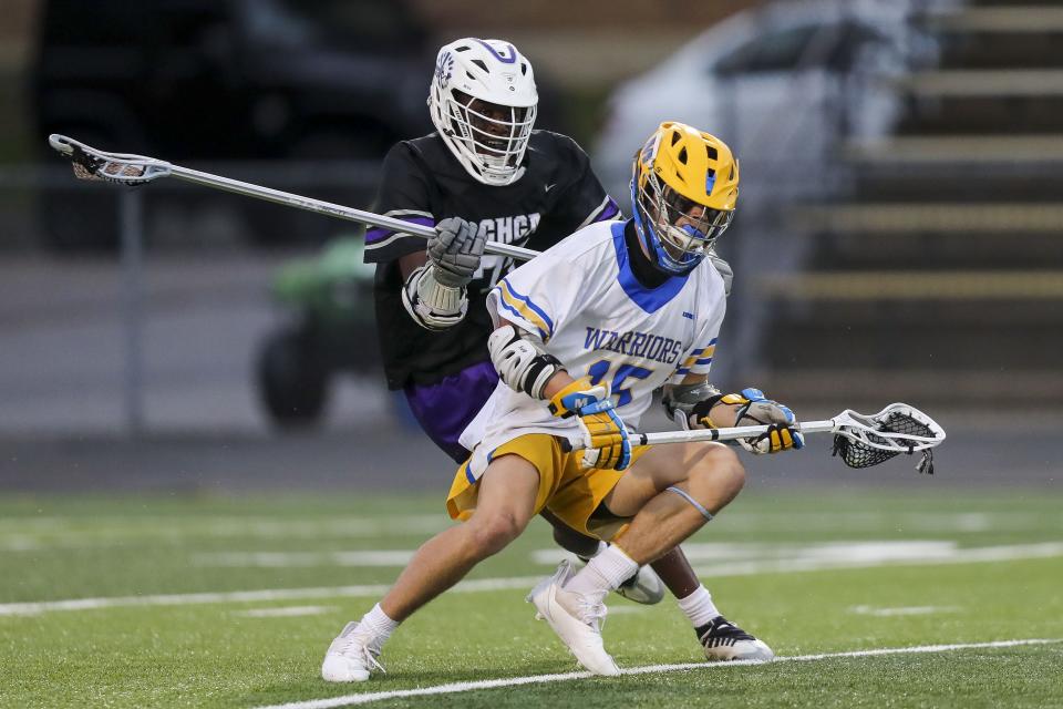 Mariemont attacker Max Tepe (15) runs with the ball against Cincinnati Hills Christian Academy defender Tobi Aina (77) in the first half at Mariemont High School May 26, 2022.