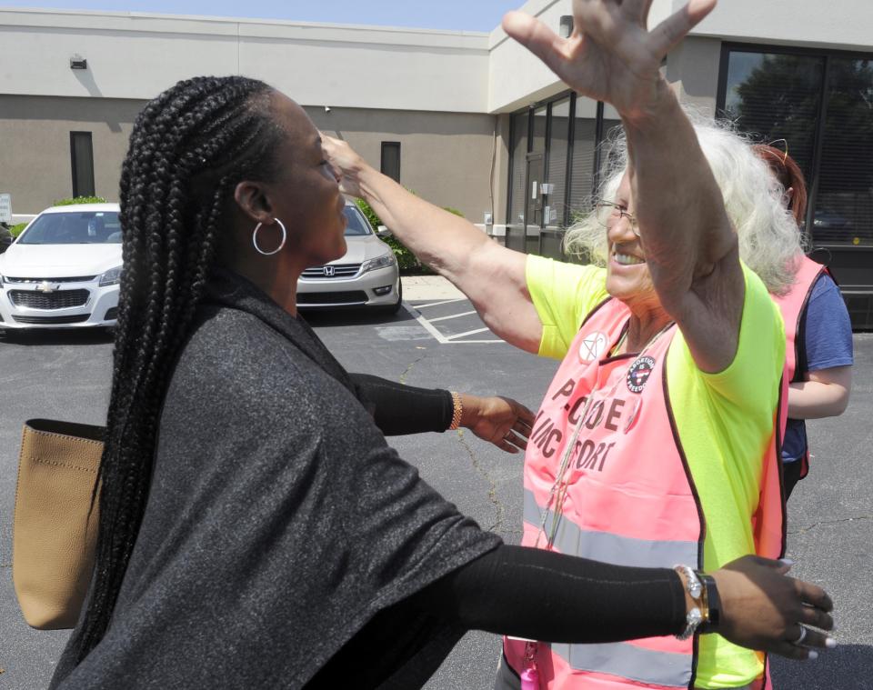 Dr. Yashica Robinson, is greeted with a hug from Josie Poland, a clinic escort, while arriving for work at the Alabama Women's Wellness Center Friday, May 17, 2019 in Huntsville, Ala. The Alabama legislation signed into law Wednesday would make performing or attempting to perform an abortion at any stage of pregnancy a felony. The ban does not allow exceptions for rape and incest.(AP Photo/Eric Schultz)