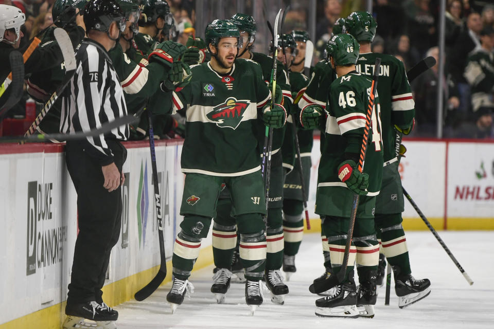 Minnesota Wild center Frederick Gaudreau, center, celebrates with the bench after scoring against the Edmonton Oilers during the second period of an NHL hockey game Monday, Dec. 12, 2022, in St. Paul, Minn. (AP Photo/Craig Lassig)